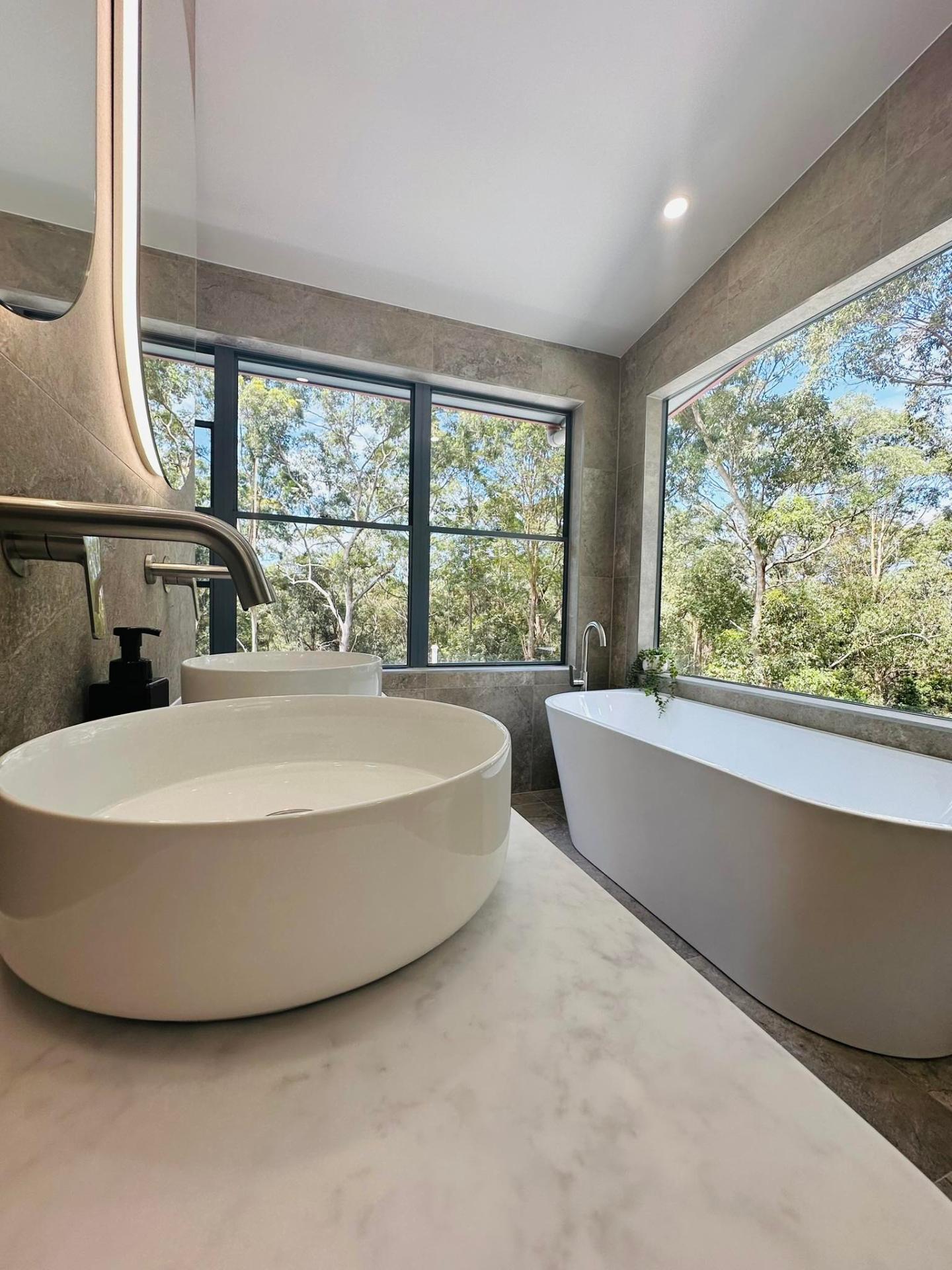 Luxury bathroom with freestanding tub and bushland views