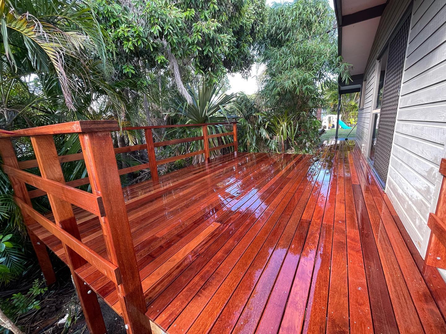 Freshly oiled hardwood deck with handrail
